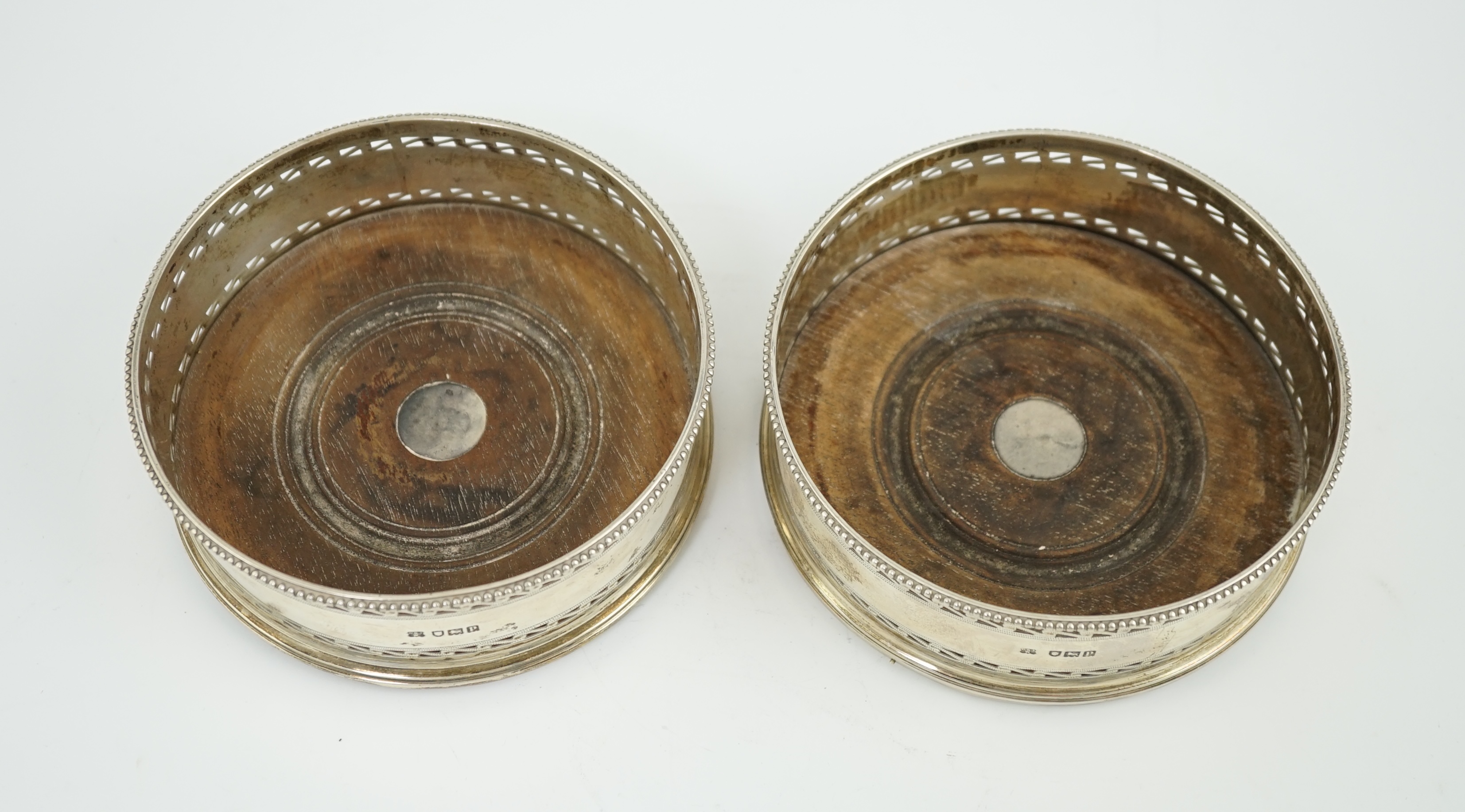 A pair of George V pierced silver mounted wine coasters, by Daniel & John Welby